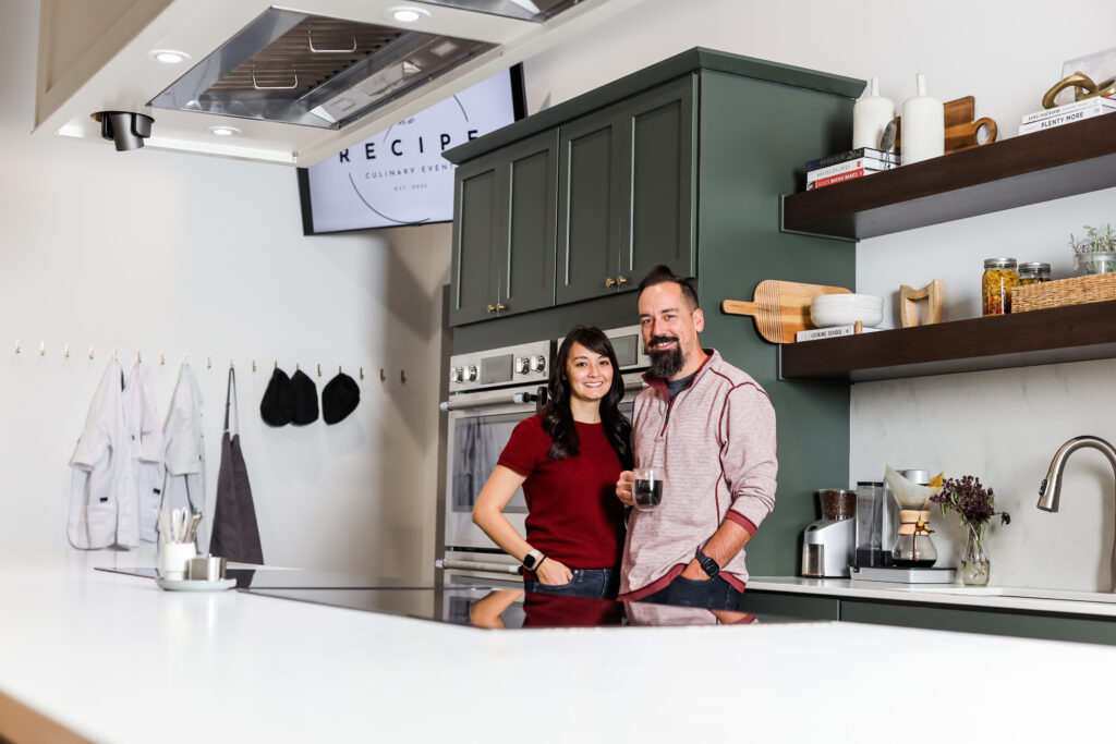 Owner of The Recipe standing in kitchen