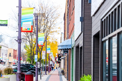 Image down the sidewalk and building of Downtown Ames