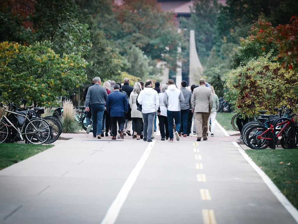 Crowd walking down bike bath at inter city visit event