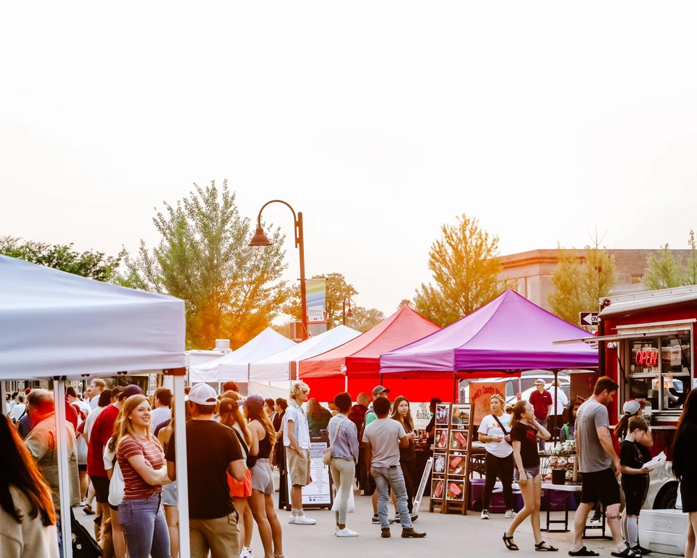 Famers Market tents and food truck lined up downtown Ames street